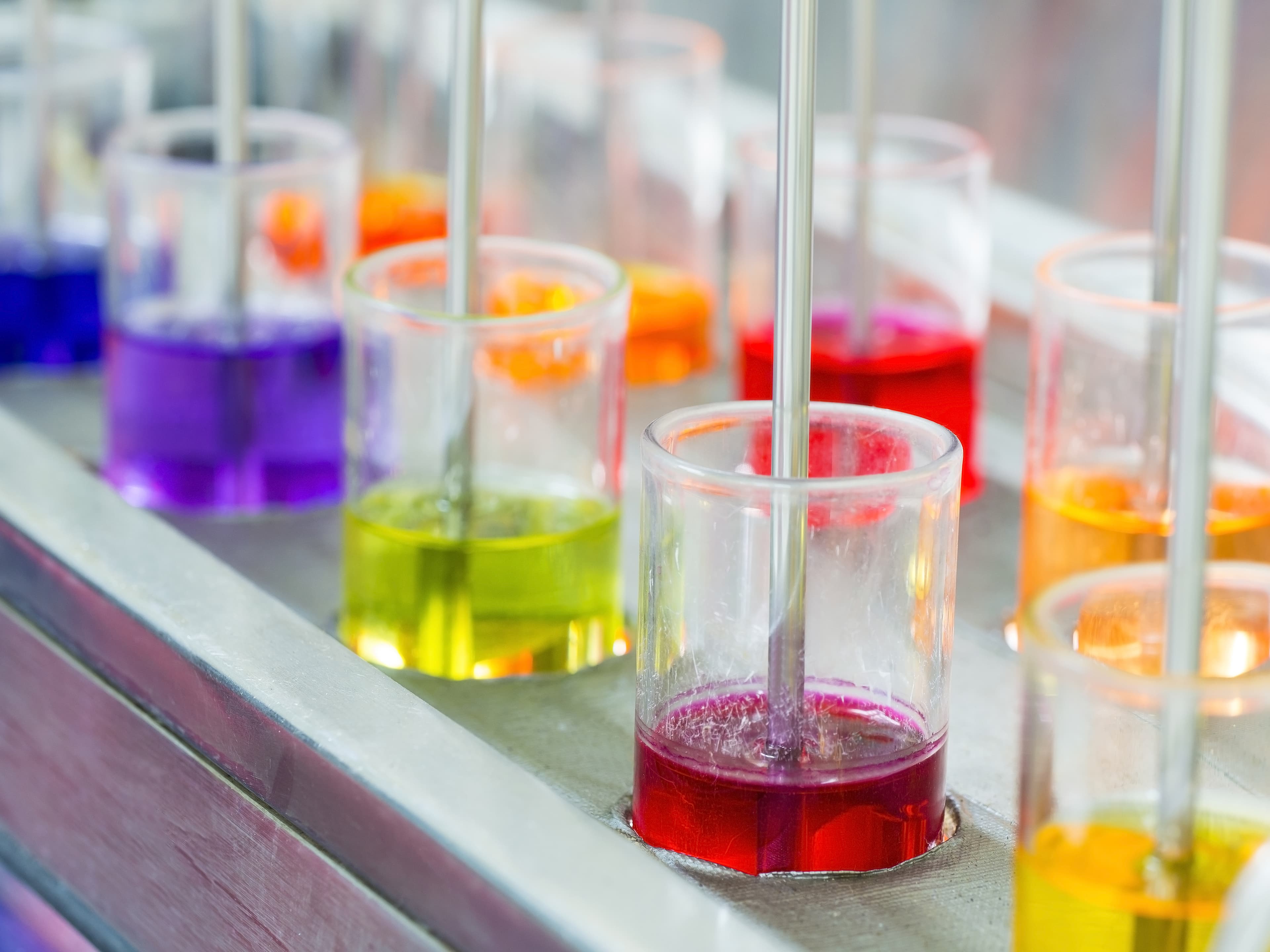 Two rows of test tubes with different colored liquids